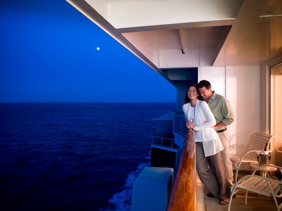 Celebrity Cruise couple leaning on balcony rail